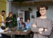 Successful woman CMO with her arms crossed in front of her team