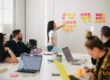 woman at wall with post-it for a web designer meeting