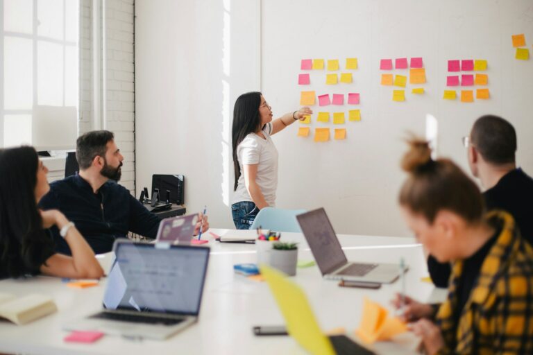 woman at wall with post-it for a web designer meeting