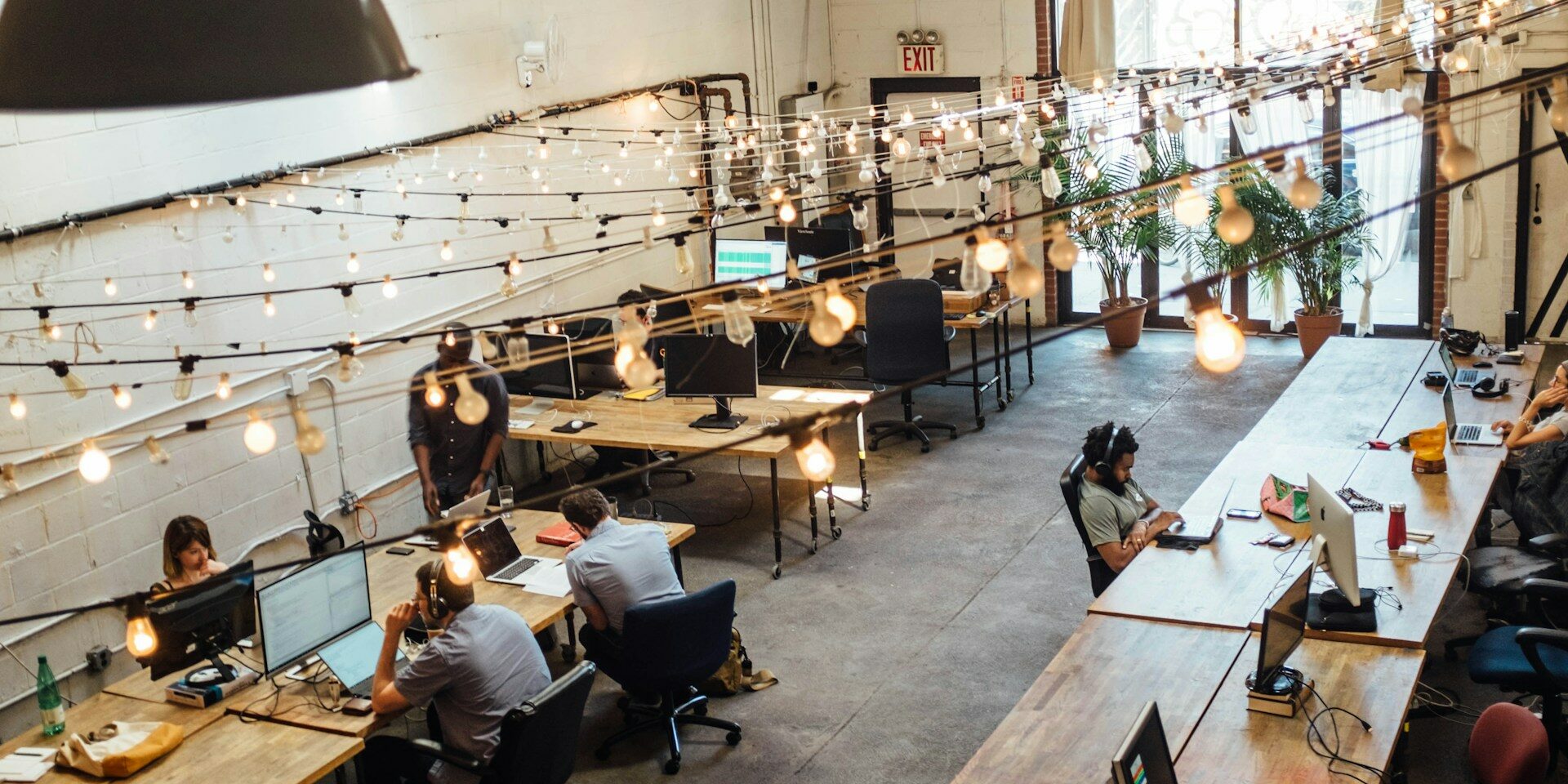 a group of professionals as part of an embedded team working in a co-working space