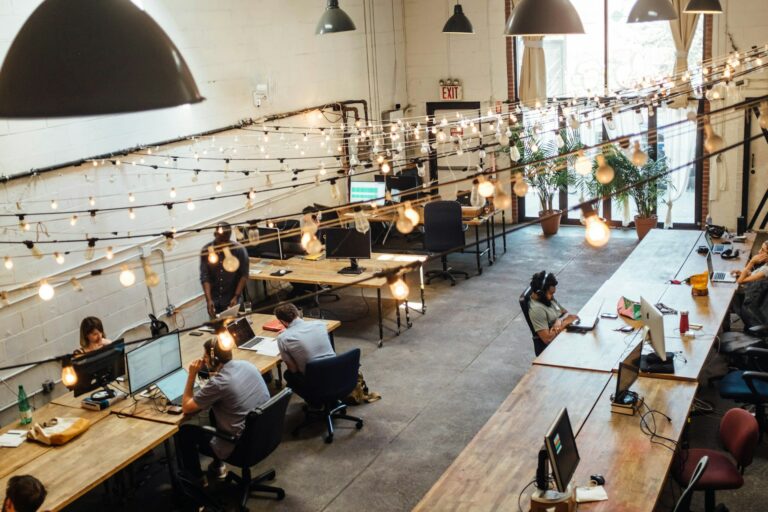 a group of professionals as part of an embedded team working in a co-working space